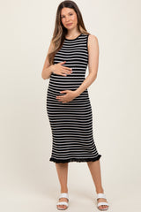 woman wearing a black and white striped maternity dress with a ruffled hem and holding her baby bump