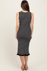 woman wearing a black and white striped maternity midi dress with a fitted silhouette and ruffle hem