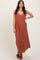 woman wearing a rust-colored sleeveless maxi dress with a v-neck and front pockets