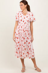 woman wearing a floral midi dress with short sleeves and a smocked bodice