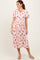woman wearing a floral midi dress with short sleeves and a smocked bodice