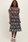 woman wearing a black and white floral print midi dress with puff sleeves and a square neckline