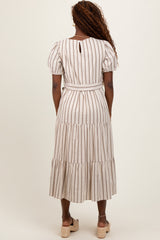 woman wearing a striped midi dress with puff sleeves and a belted waist, shown from the back