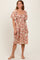 woman wearing a floral midi dress with puff sleeves and a cinched waist, standing on a neutral background