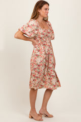 woman wearing a floral print midi dress with puff sleeves and a fitted waist in a side pose