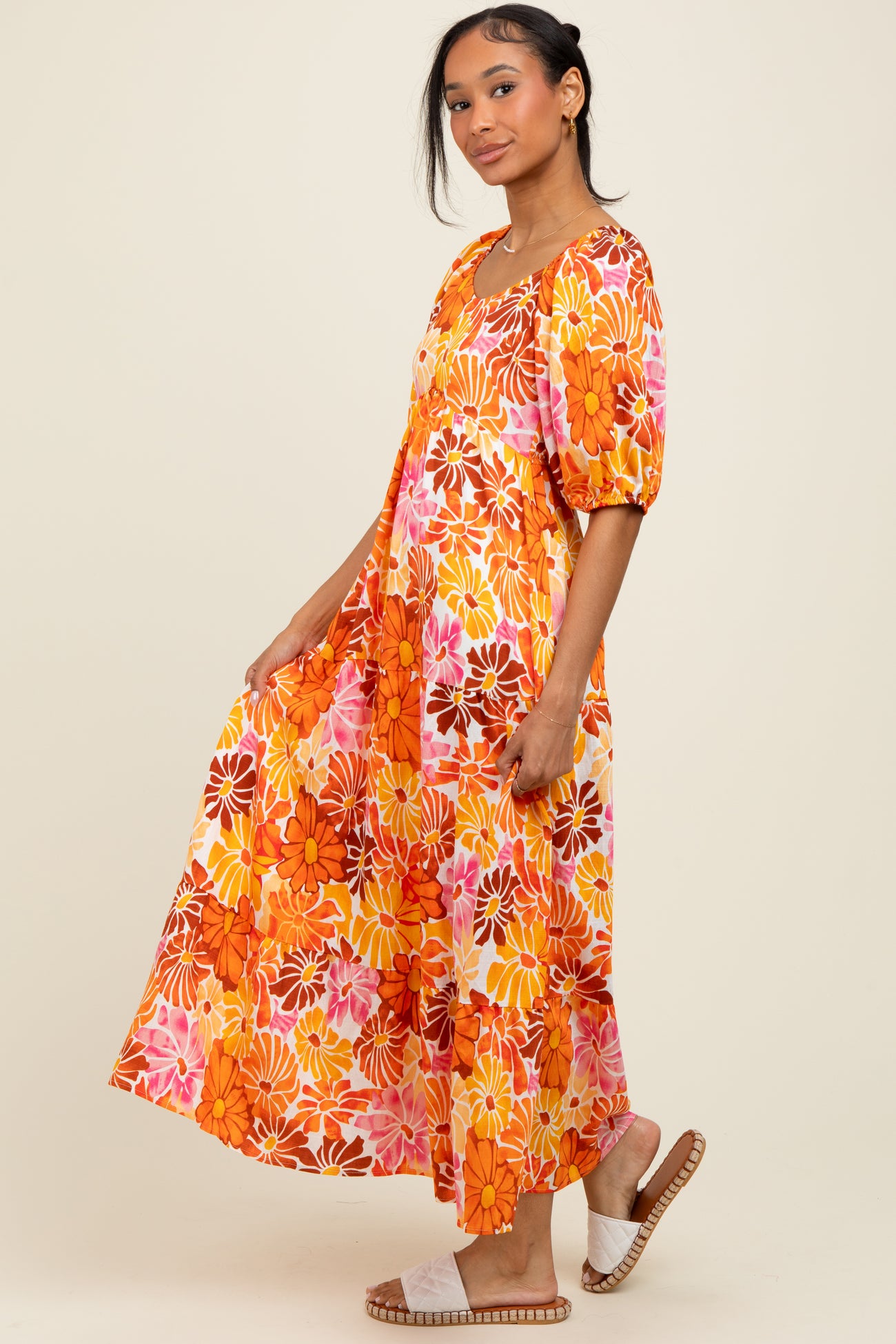 woman wearing a vibrant floral maxi dress with puff sleeves and a flared skirt
