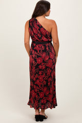 woman wearing a black and red floral maternity maxi dress with an asymmetrical neckline and tied waist