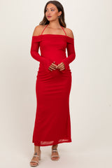 woman wearing a red off-the-shoulder maternity dress with long sleeves and a fitted silhouette