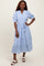 woman wearing a light blue tiered midi dress with puff sleeves and a tie waist detail