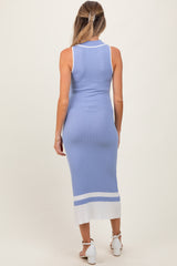 woman wearing a light blue ribbed maternity dress with a white hem detail, showing her back and fitted silhouette