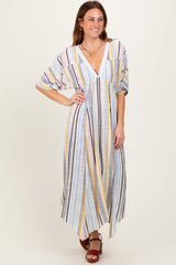 woman wearing a pastel striped maxi dress with a v-neck and wide sleeves