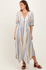woman wearing a multi-colored striped maxi dress with short sleeves and a deep V-neckline