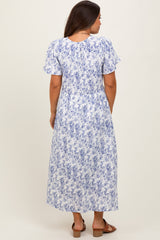 woman wearing a blue and white floral print maternity maxi dress, shown from the back
