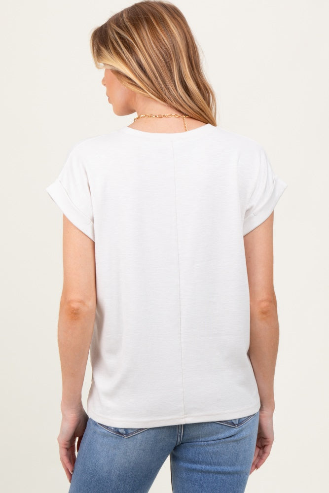 woman wearing a light gray short sleeve maternity top, viewed from the back, paired with blue jeans