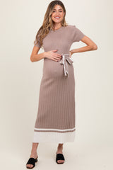 woman wearing a taupe ribbed maternity dress with short sleeves and a tie on the waist, showing her baby bump