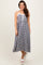 woman wearing a black and white gingham midi dress with adjustable straps and a drawstring detail