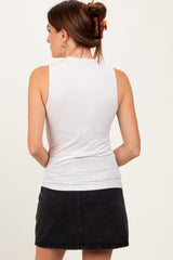 woman wearing a white sleeveless top with a fitted style and a black denim mini skirt, viewed from the back