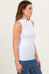 woman wearing a white sleeveless ribbed top with a high neckline and light blue jeans
