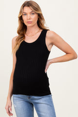 woman wearing a black ribbed maternity tank top and showing her baby bump