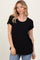 woman wearing a black short sleeve t-shirt with a pocket and a relaxed fit, styled with light blue jeans