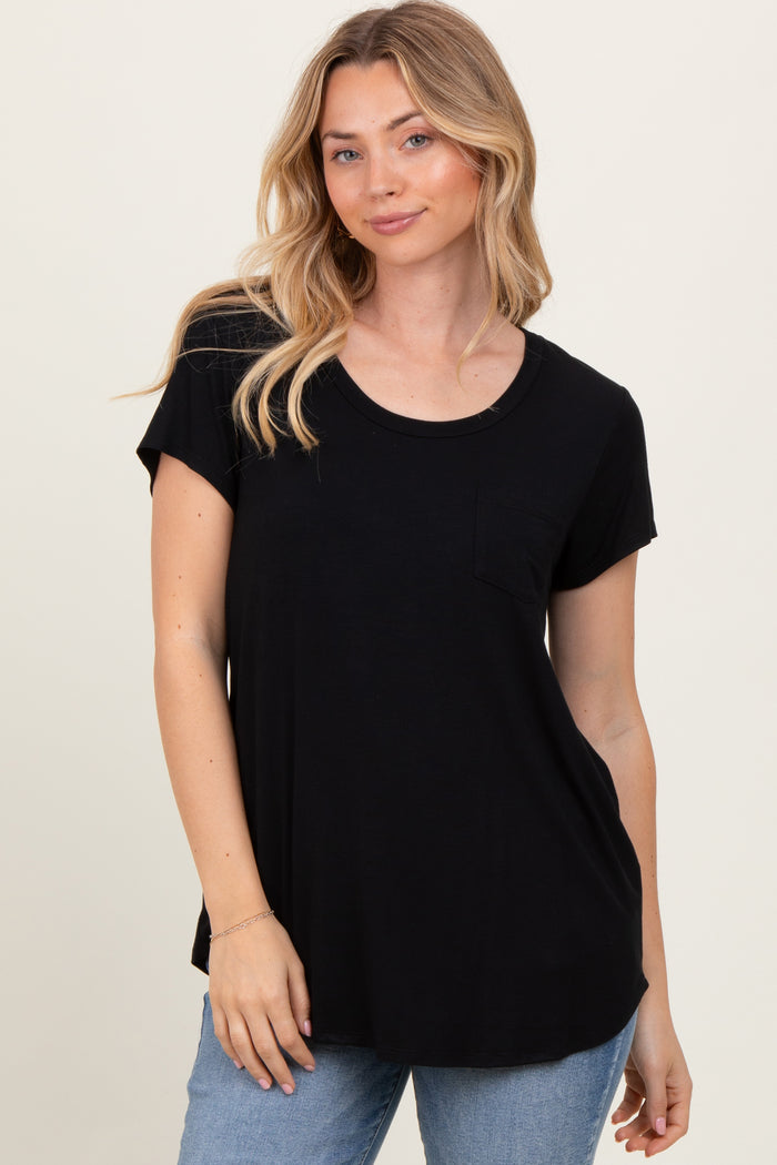 woman wearing a black short sleeve t-shirt with a pocket and a relaxed fit, styled with light blue jeans