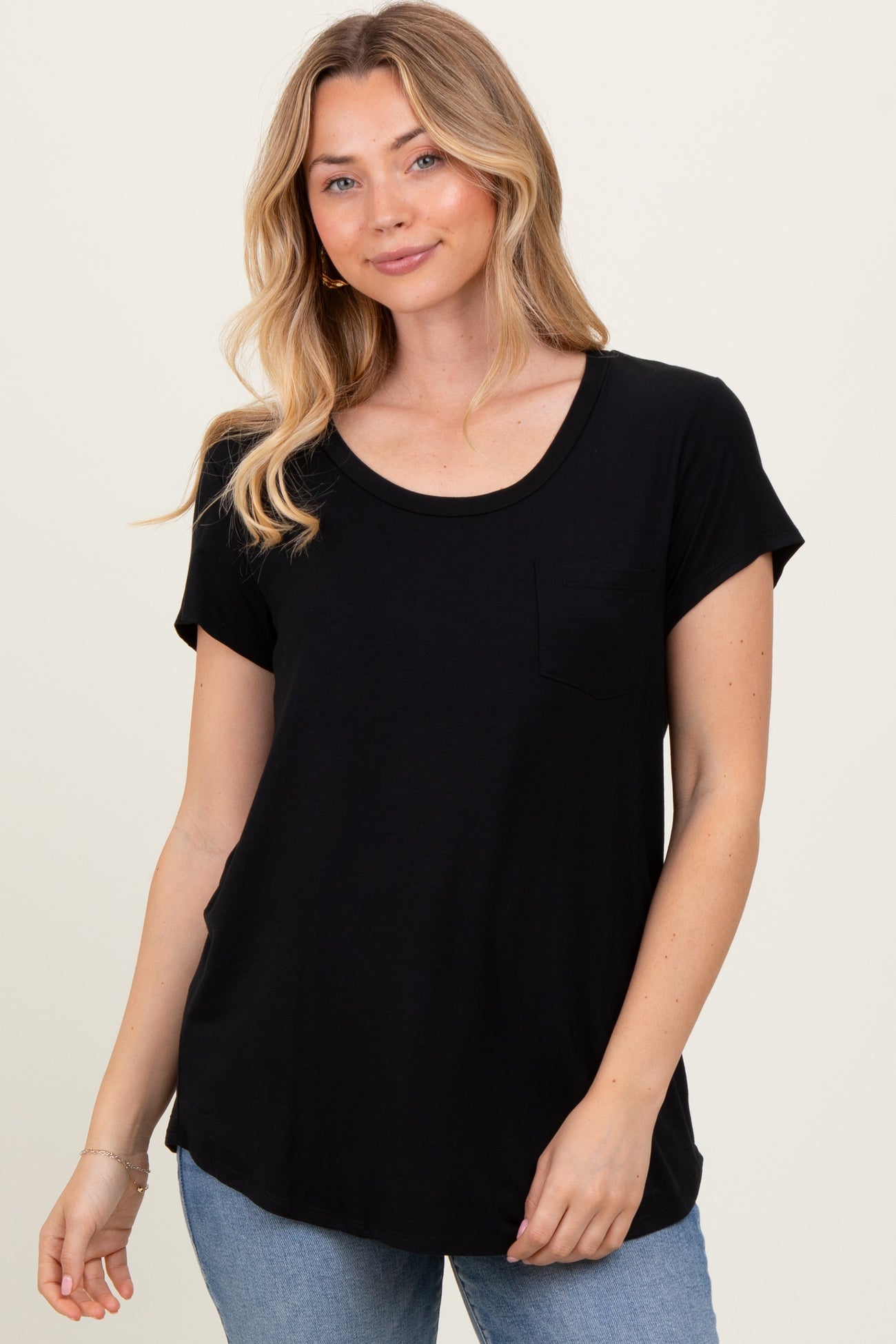 woman wearing a black short sleeve t-shirt with a pocket and a relaxed fit