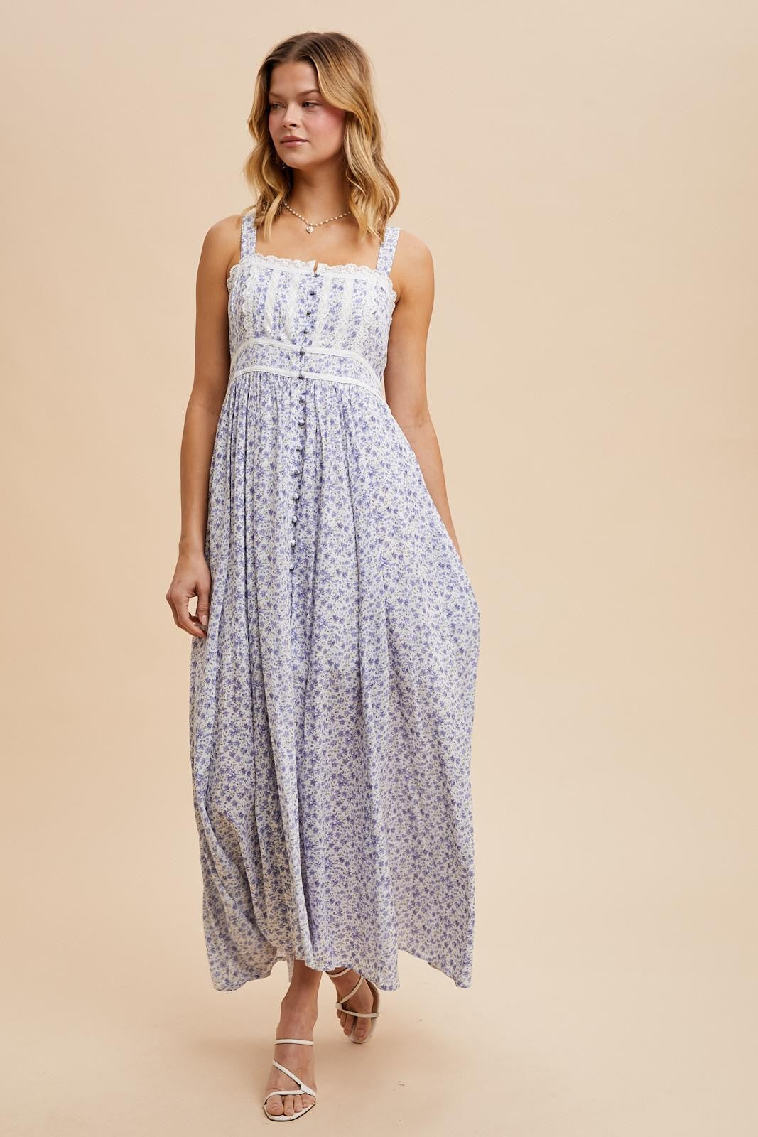 woman wearing a lavender floral maxi dress with thin straps and a fitted bodice