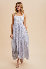 woman wearing a lavender floral maxi dress with thin straps and a fitted bodice