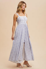 woman wearing a white floral maxi dress with adjustable straps and a button-down front