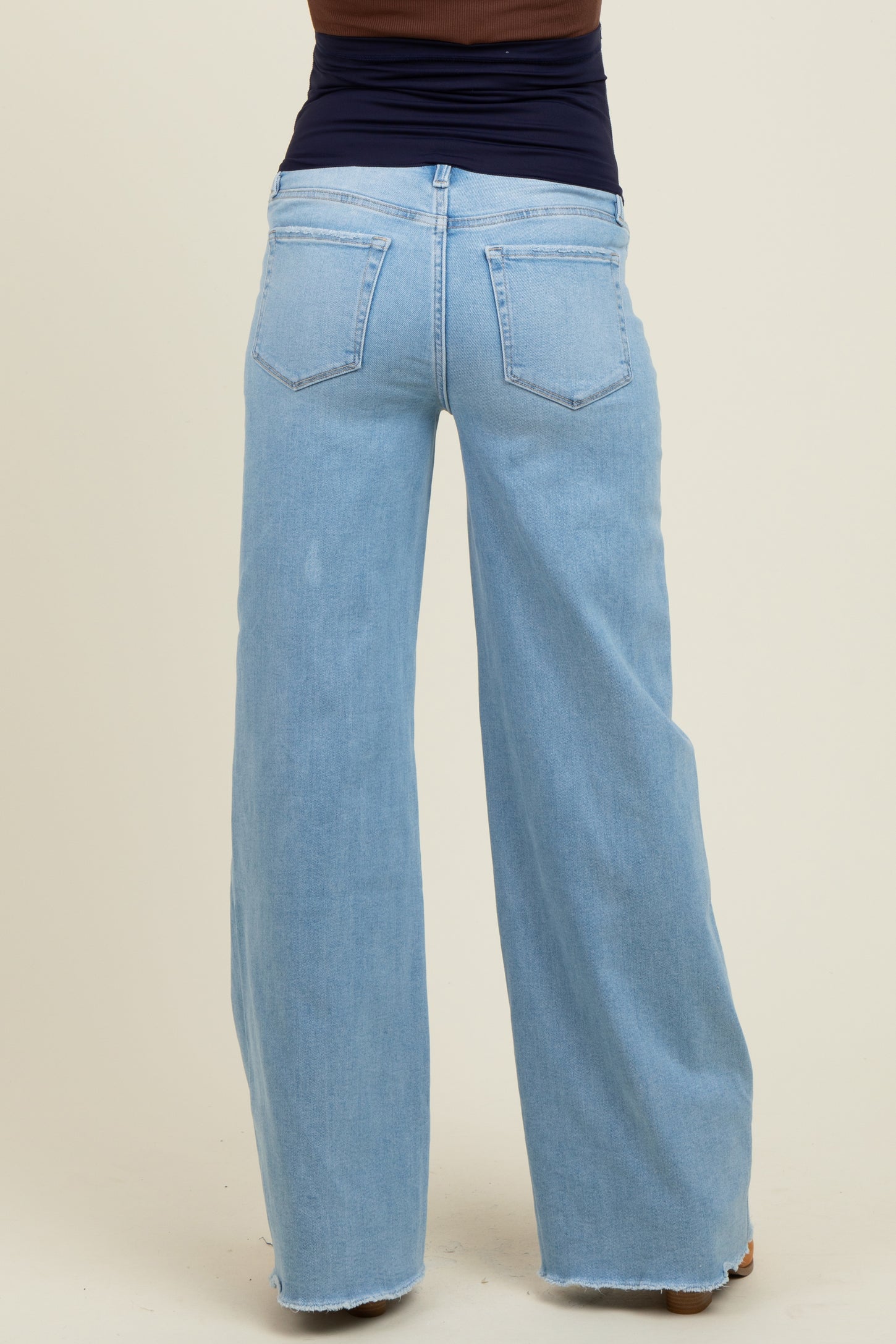 woman wearing light wash wide-leg maternity jeans, seen from the back