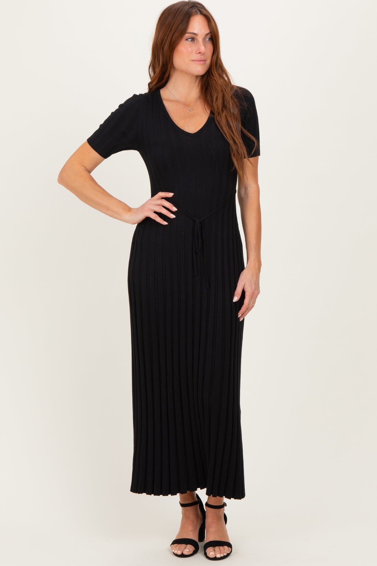 woman wearing a black short sleeve ribbed maxi dress with a drawstring waist and a v-neckline