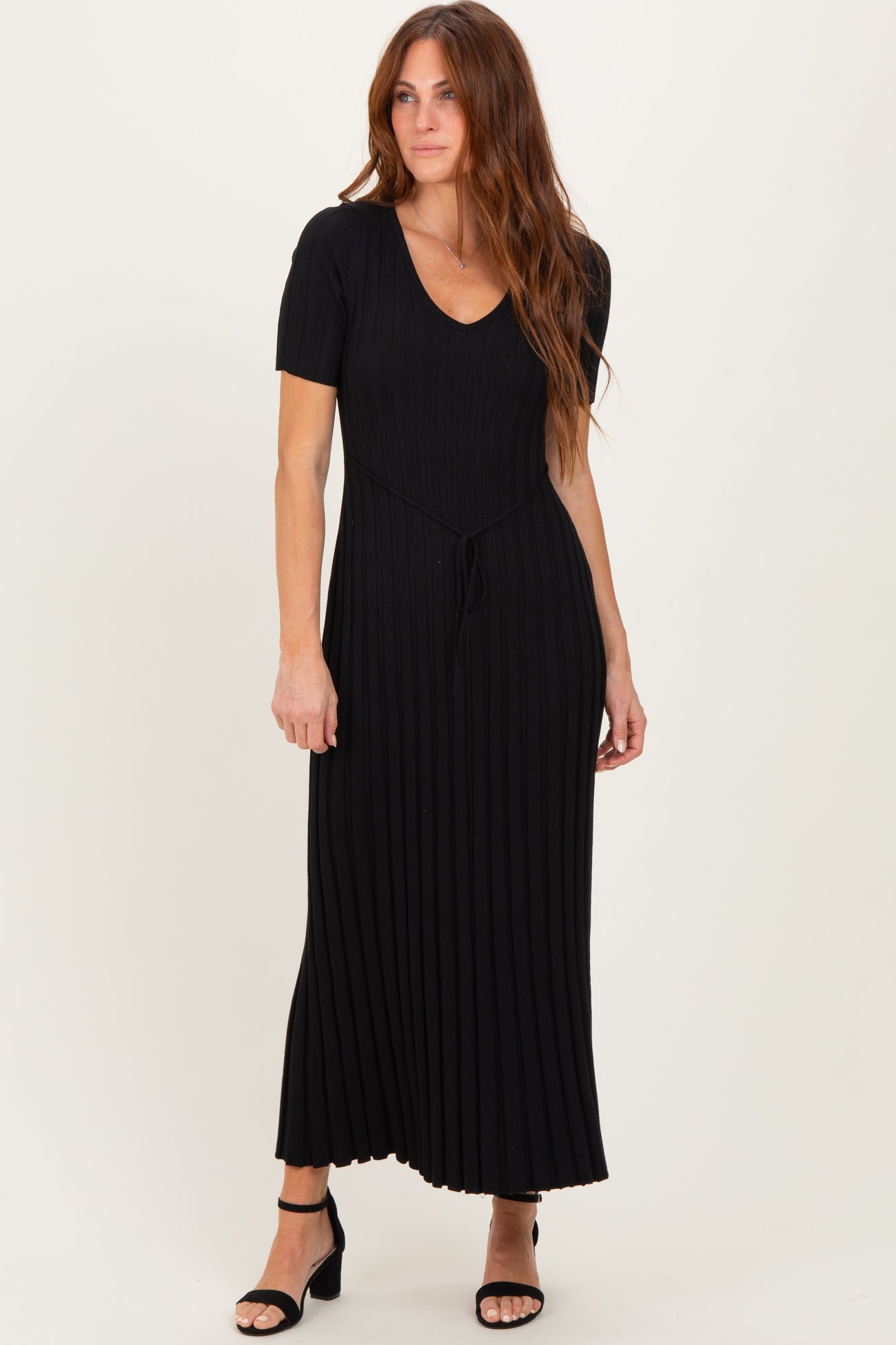 woman wearing a black ribbed maxi dress with a tie waist and short sleeves