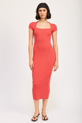 woman wearing a coral ribbed midi dress with cap sleeves and a square neckline