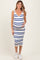 woman wearing a white and blue striped maternity dress, showing her baby bump, styled with white sneakers