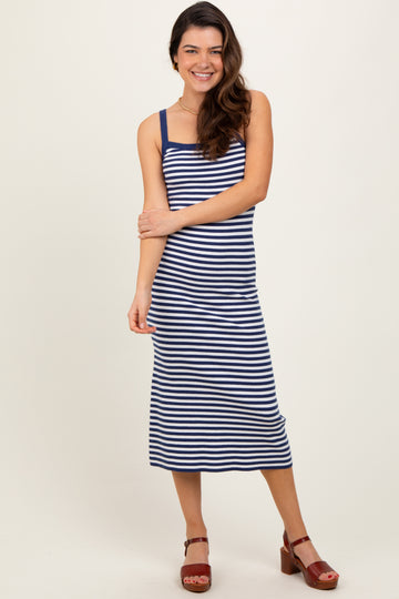 woman wearing a navy and white striped midi dress with spaghetti straps and brown platform sandals