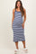 woman wearing a navy and white striped maternity dress with a fitted silhouette and spaghetti straps, showing her baby bump