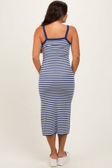 woman wearing a navy and white striped maternity dress with a fitted silhouette and spaghetti straps, showing her back