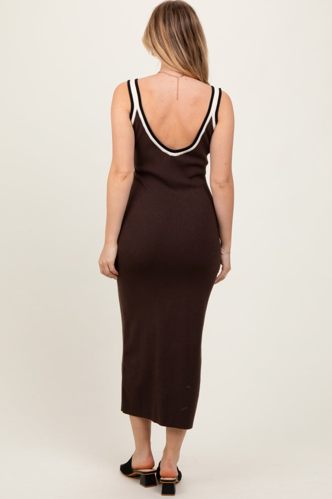 woman wearing a brown sleeveless maxi dress with a plunging back and white trim details