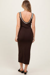 woman wearing a brown sleeveless maxi dress with a plunging back and white trim details