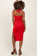 woman wearing a red maternity dress with back tie and side slit, showcasing a baby bump
