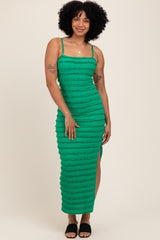 woman wearing a green striped midi dress with a side slit and spaghetti straps