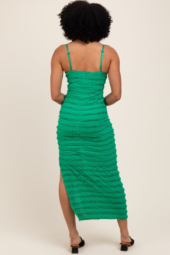woman wearing a green midi dress with textured ruching and a side slit, shown from the back