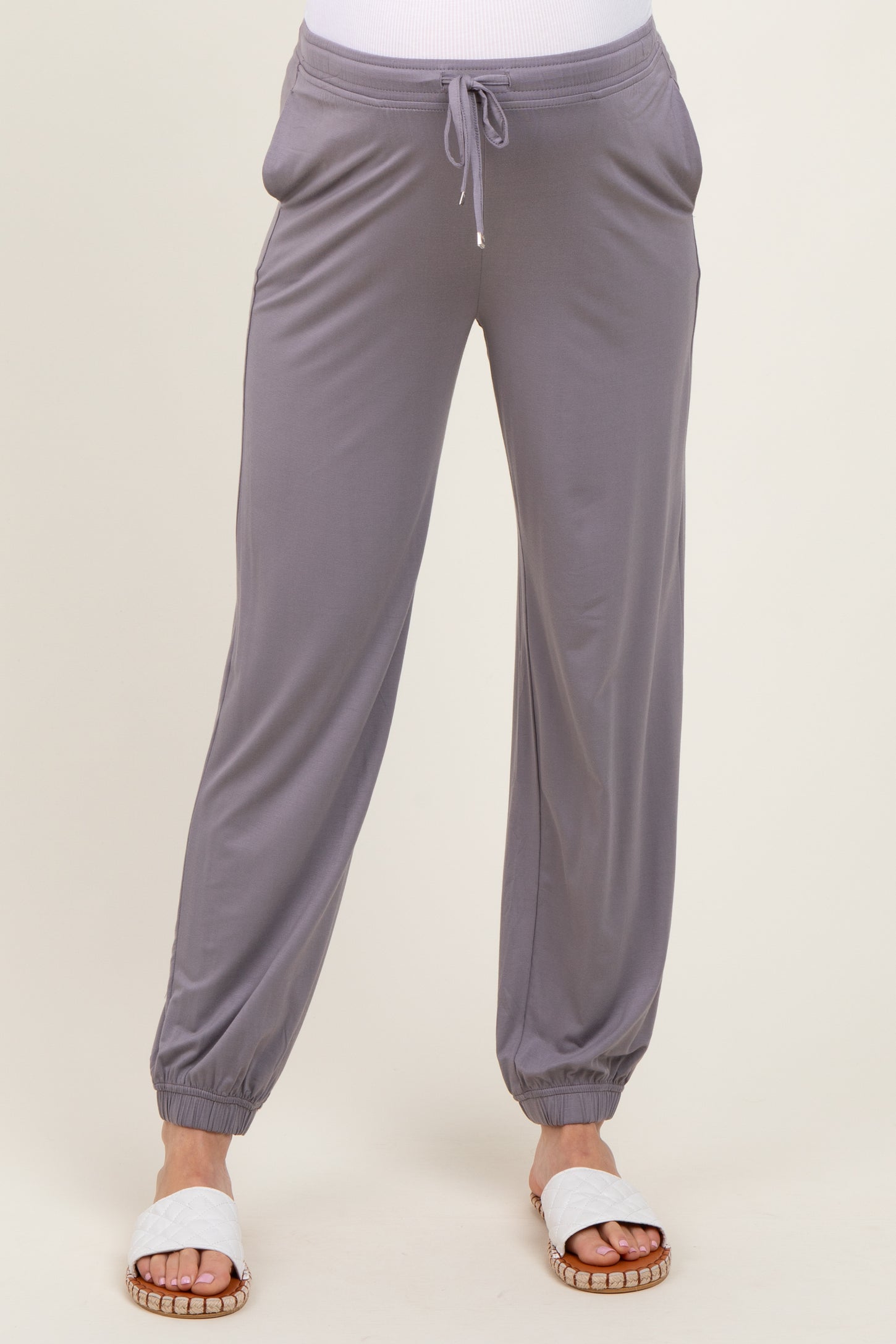 woman wearing gray maternity jogger pants with an elastic waistband and side pockets