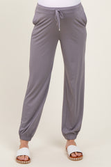 woman wearing gray maternity jogger pants with an elastic waistband and side pockets