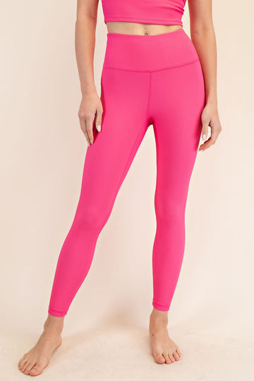woman wearing hot pink ribbed leggings with a high waistband