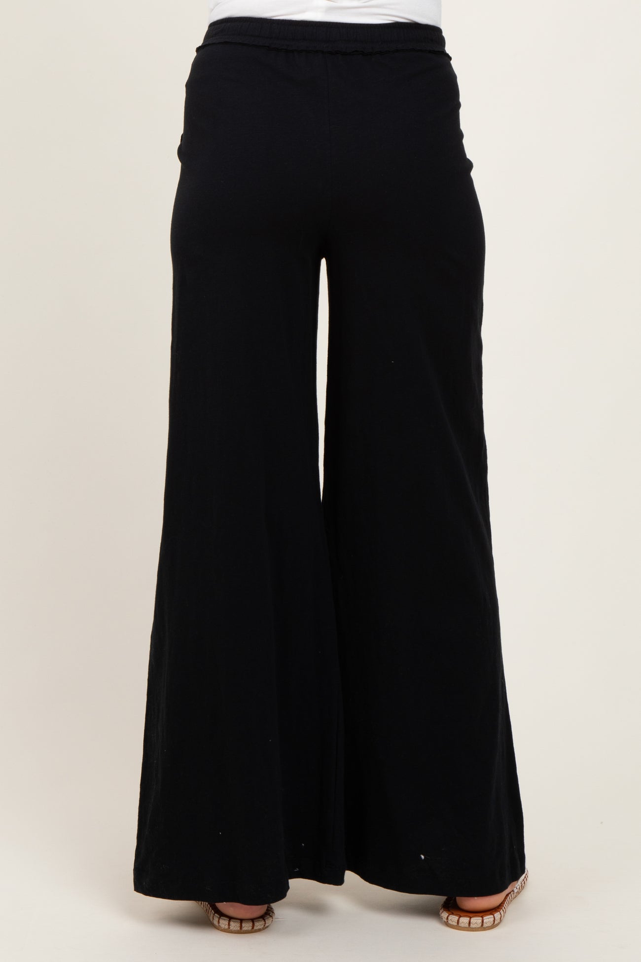 woman wearing black wide-leg maternity pants seen from the back