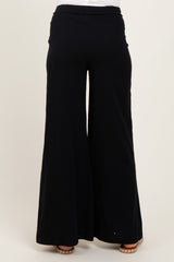 woman wearing black wide-leg maternity pants seen from the back