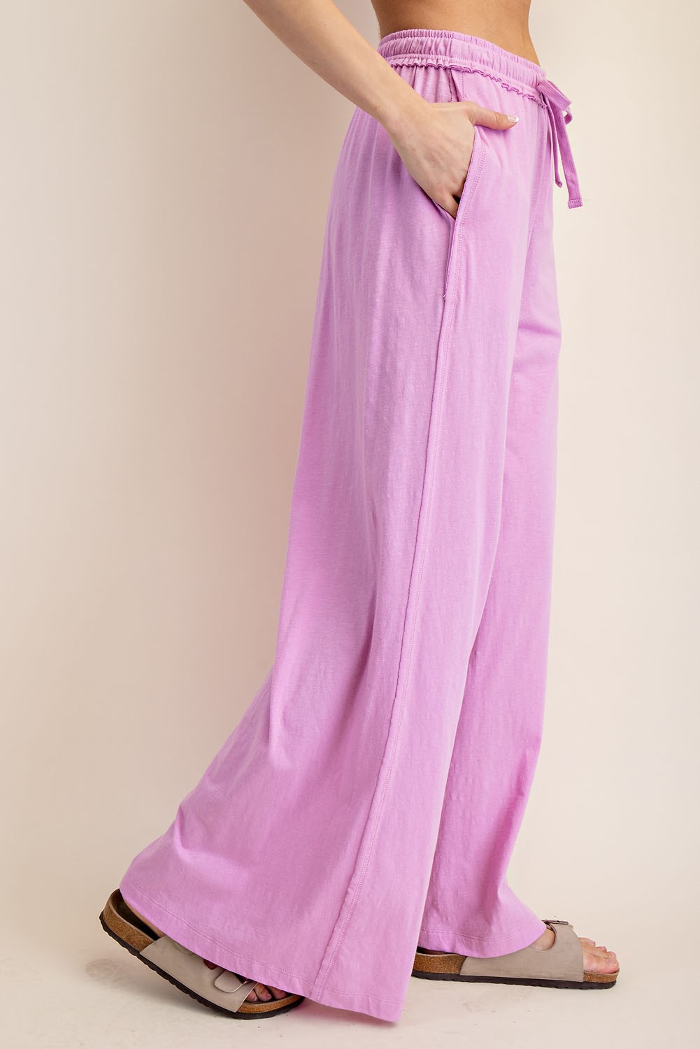 woman wearing light pink wide-leg pants with an elastic waistband and side pockets