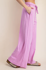 woman wearing light pink wide-leg pants with an elastic waistband and side pockets