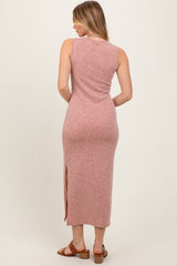 woman wearing a pink ribbed maxi dress with a side slit, shown from the back